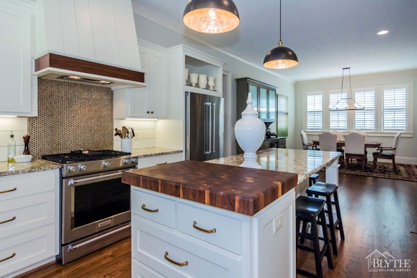 Butcher block countertop insert in kitchen island|Blythe Building Company