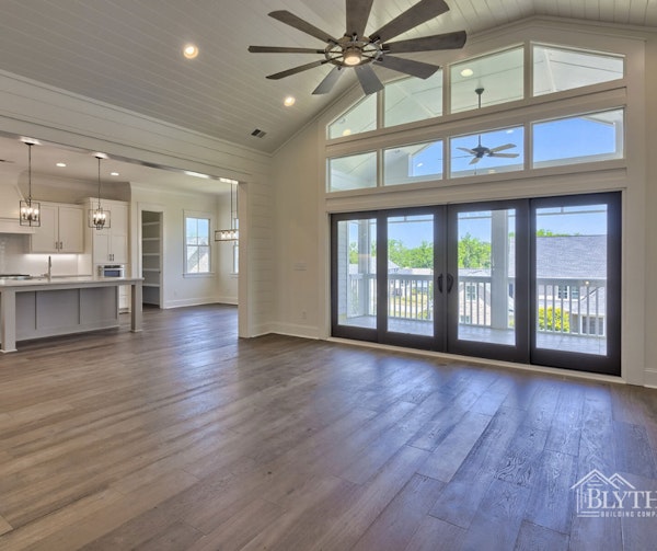 Shiplap wall and ceiling with wall of windows and glass doors