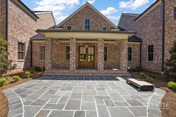 Blue Slate Patio Leading To Front Porch Of Large Brick House 1