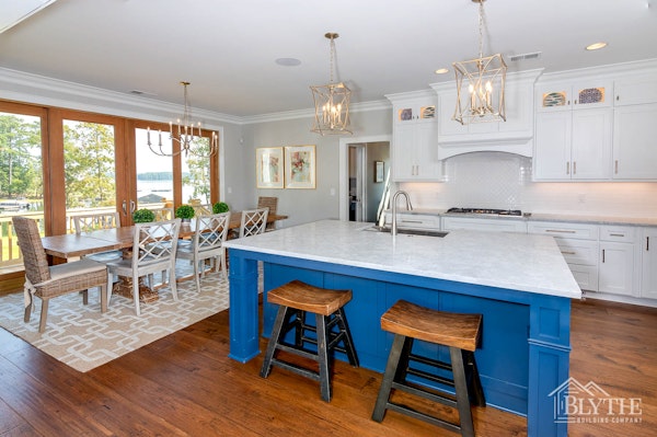 White Kitchen with lake view and With blue kitchen Island 1