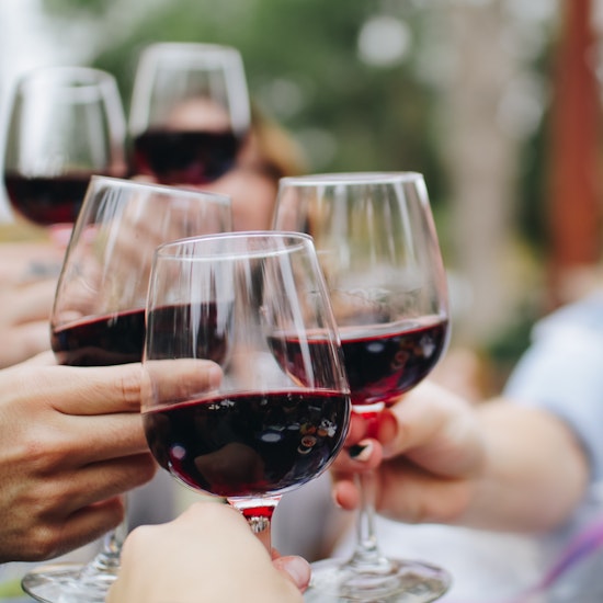 close-up-of-people-holding-wine-glasses-for-a-toast.jpg