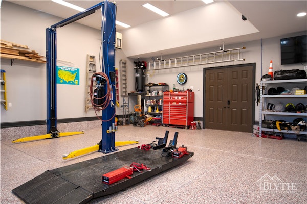 Custom Home Garage With Car Lift, Vaulted Ceilings, and garage floor epoxy coating