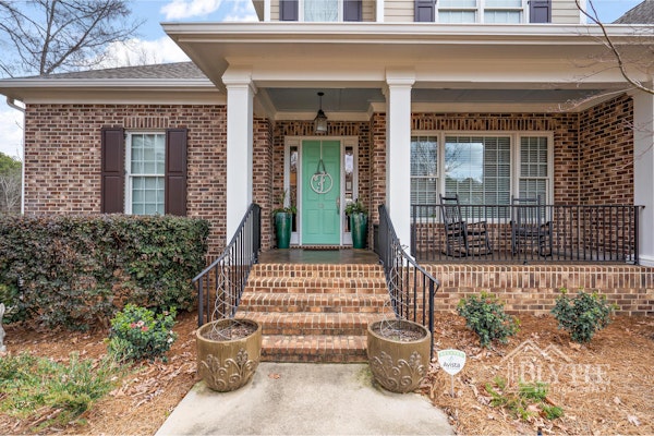 Craftsman Style Brick Front Porch And Bright Green Front Door With Hanging Black Lantern