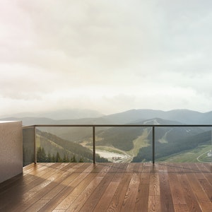 Tropical hardwood custom deck with glass railing overlooking mountains