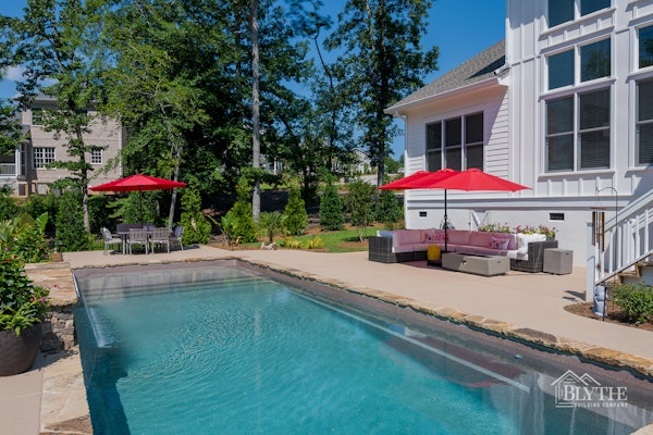 Custom in-ground pool and patio area behind custom Craftsman home in Lexington, SC