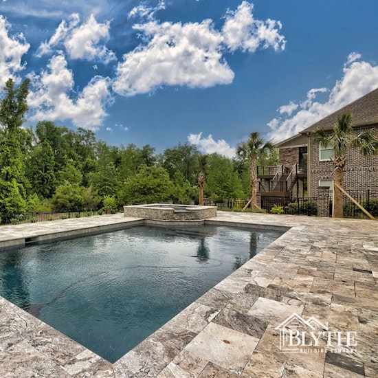 Custom In Ground Luxury Pool And Spa With Natural Stone Pool Decking Overlooking The Woods  1