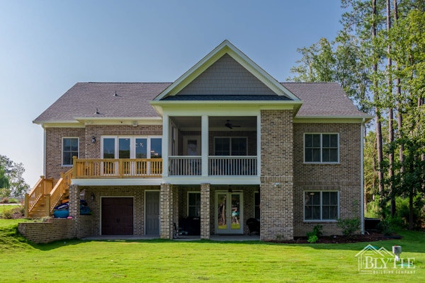 Rear exterior of brick Lake Murray home and grassy yard