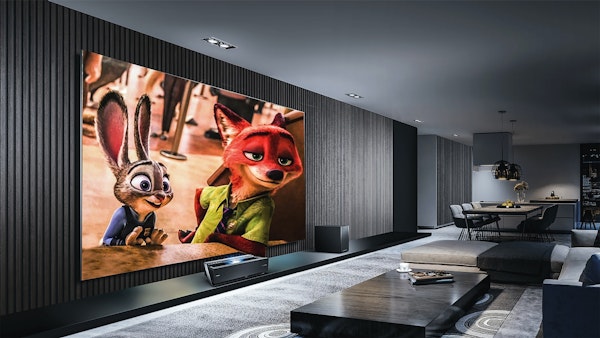 Luxury home movie theater with large screen, dark gray walls, and light gray carpet