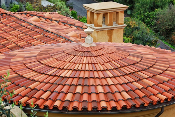 Red tile terracota roof on Mediterranean style home.