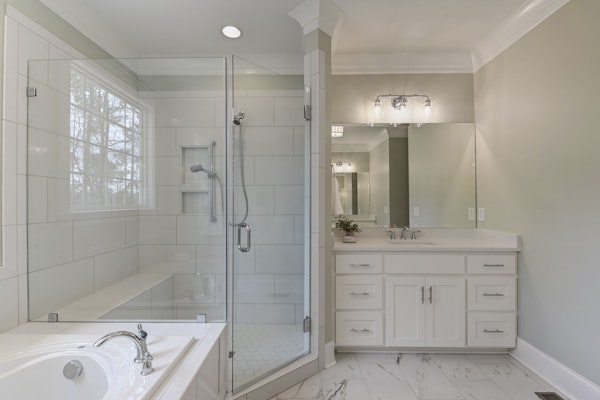 King Spec Home Plan Luxury Master Bathroom with drop-in tub and oversized custom shower and two vanities