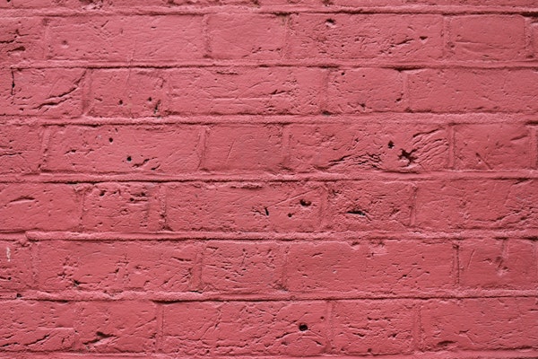 Beaded Mortar Joints In A Brick Wall That Is Painted Red