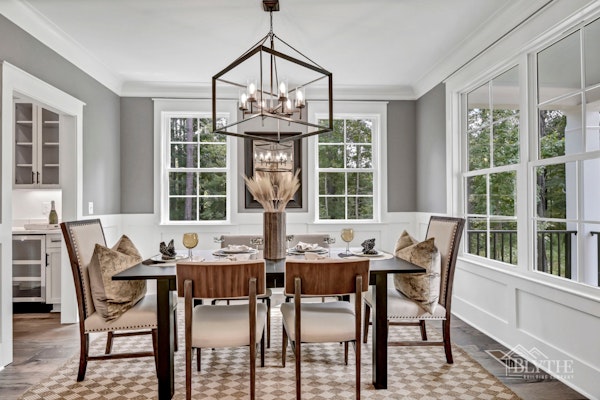 Formal Dining Room With Wainscoting And View Of Adjacent Butlers Pantry With Wine Cooler