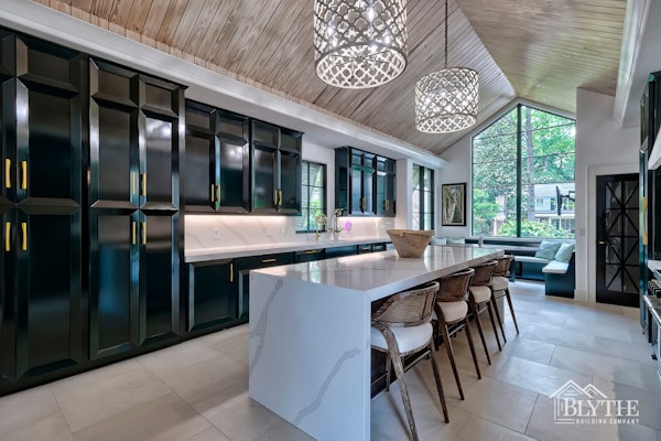 Dramatic Kitchen With Black Custom Floor To Ceiling Cabinets Vaulted Wood Paneled Ceiling Oversized Cylindrical Chandeliers Large Format Rectangular Floor Tile And Waterfall Kitchen Island