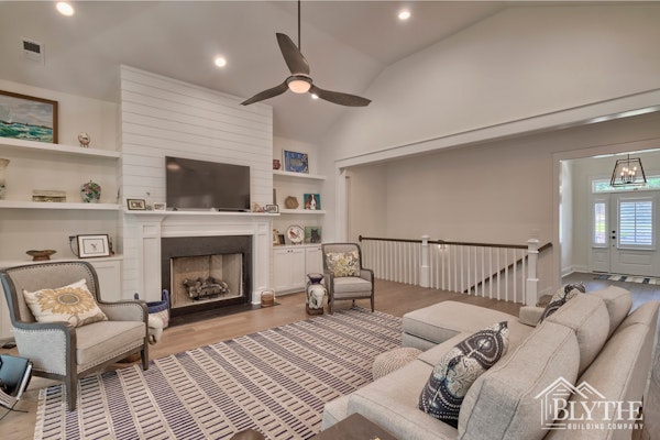 White Shiplap Fireplace Wall With White Mantel And Custom Built In Bookshelves And Cabinets On Each Side Of The Fireplace 1