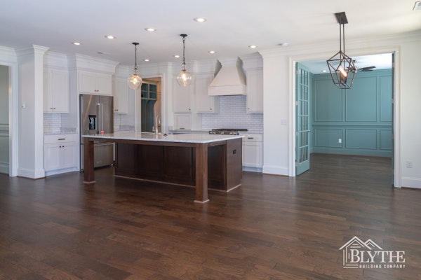 Modern Craftsman Kitchen With Glass Pendant Lights Stained Wood Kitchen Island White Shaker Cabinets White Subway Tile And Stainless Steel Appliances 2