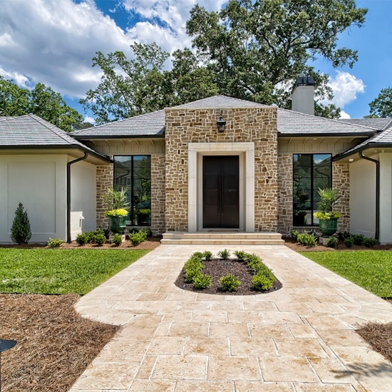Elegant One Story Home With Stone Veneer And Large Natural Stone Sidewalk With Oval Landscaping In The Center