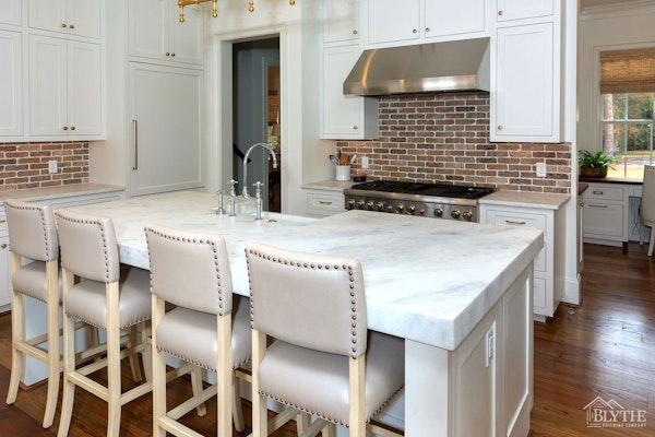 Luxury Kitchen With Thin Brick Backsplash Custom Island White Cabinets And Hardwood Floors