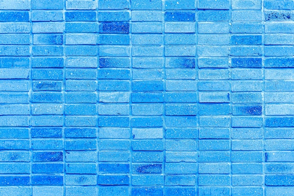 Mottled blue painted brick wall