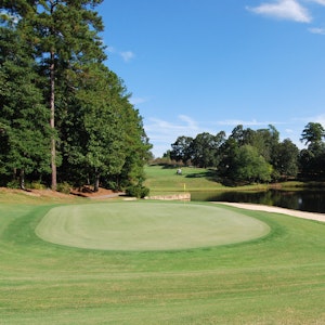 Golf Hole Near A Pond With Golf Cart In The Background Lexington Sc