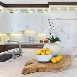 White kitchen cabinets with under-cabinet lighting and staging