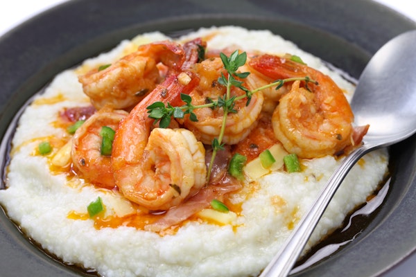 South Carolina shrimp and grits on a plate with a spoon.