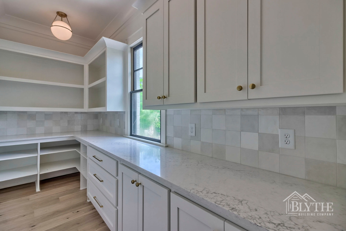 Large Kitchen Pantry With Many Custom Cabinets Shelves And Plenty Of Counter Space For Food Prep And A Window For Natural Light