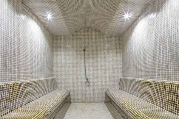 Steam room or Turkish bath in a luxury hotel with one-inch square tile.