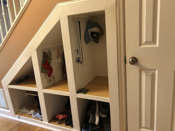 Entryway with built-in cubbies for storage and a coat closet