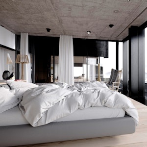 Luxury bedding in a luxury master bedroom that overlooks the ocean