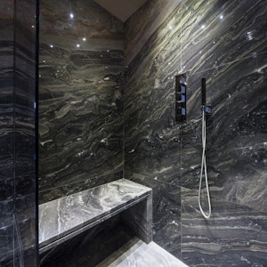 dark marble shower with dramatic veining